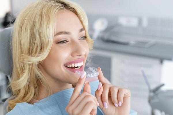 woman holding clear aligners in Augusta
